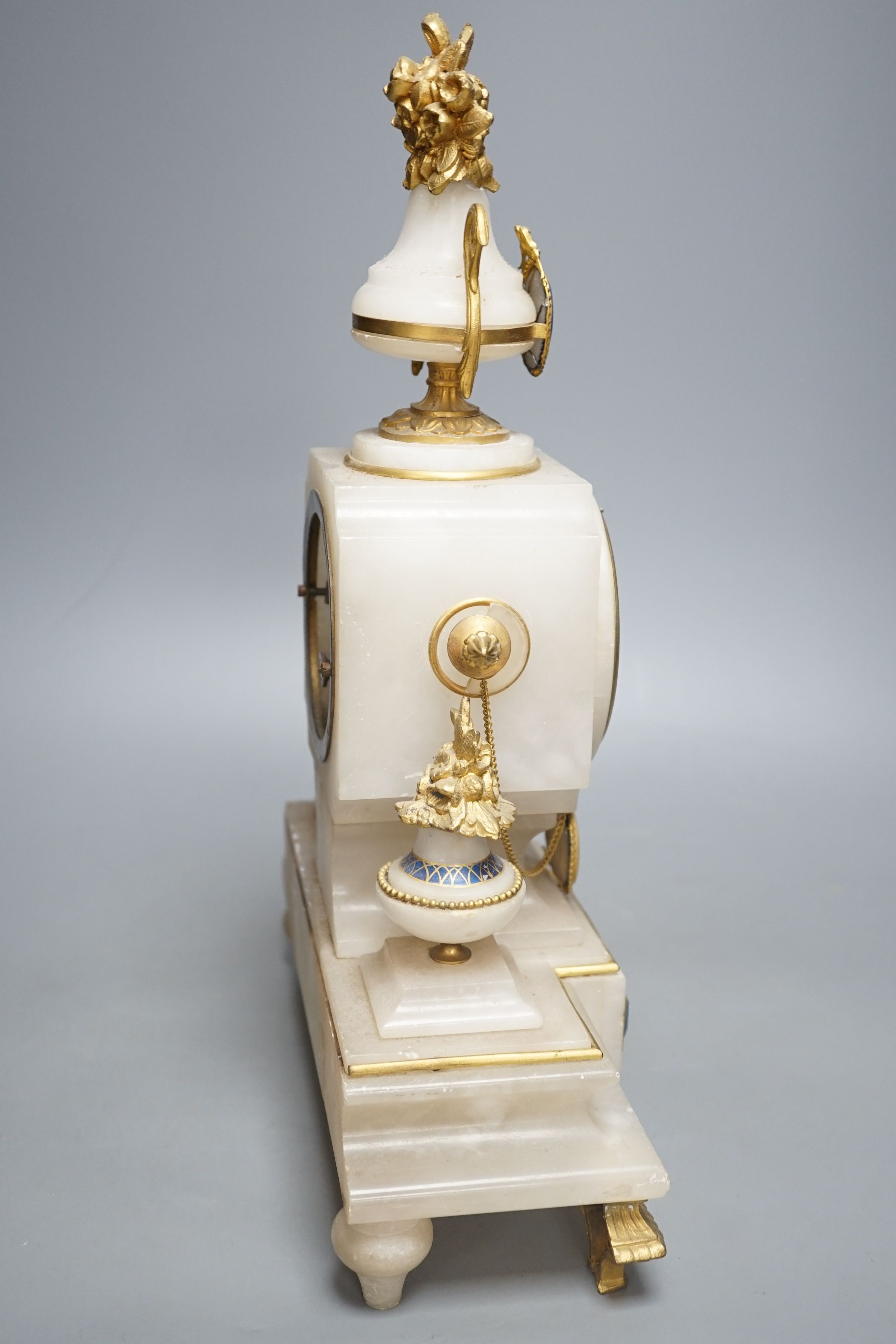 A late 19th century French alabaster and ormolu mounted mantel clock with key and pendulum - 39cm tall